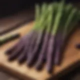 Delicate purple asparagus spears on a wooden cutting board