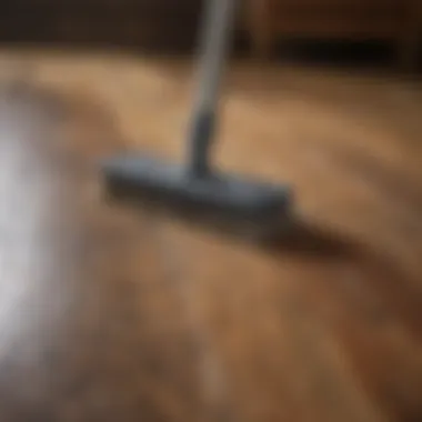 Old wood floor being gently cleaned with natural bristle brush