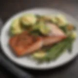 A plate of grilled salmon with asparagus and avocado