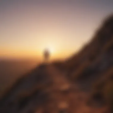 Silhouette of a person walking uphill at sunrise