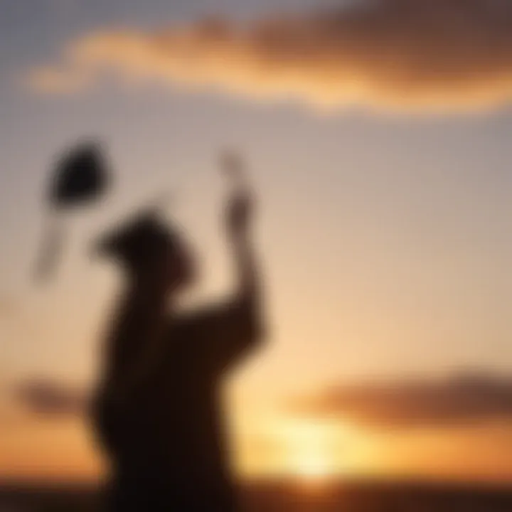 Sunset silhouette of a graduate tossing cap in the air