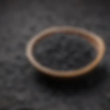 A close-up of activated charcoal in a bowl, highlighting its texture and color.