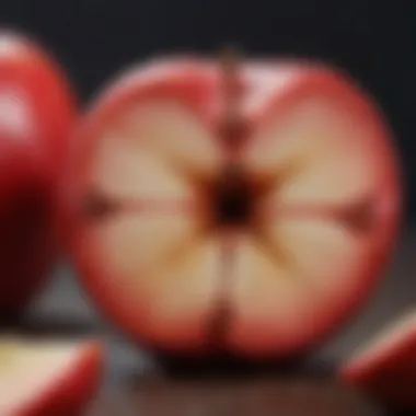 A close-up of a vibrant red apple sliced open to reveal its seeds